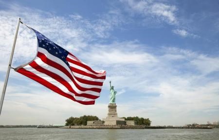An U.S. flag waves in the wind on a boat near the Statue of Liberty in New York August 31, 2011.